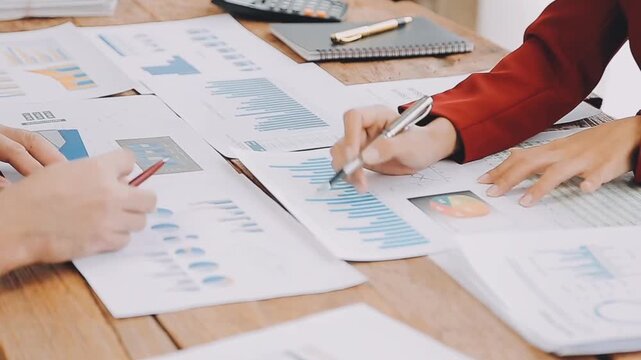 Business team analyzing financial charts and data reports during a professional meeting in an office environment