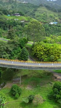 La Estampilla Curved Viaduct Crossing Mountain Terrain near Manizales, Colombia. Aerial View. Vertical Video.