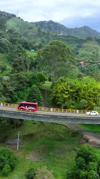 La Estampilla Curved Viaduct Crossing Mountain Terrain near Manizales, Colombia. Aerial View. Vertical Video.
