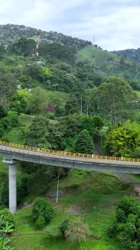 La Estampilla Viaduct with Traffic near Manizales, Colombia. Establishing Shot. Aerial View. Vertical Video.