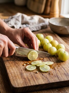 Fresh Green Indian Gooseberries Sliced on Wooden Cutting Board at Morning