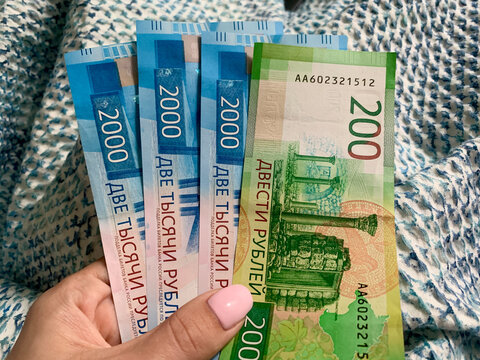 Russian ruble new bills 200 and 2000 banknotes held in a woman's hand, close-up