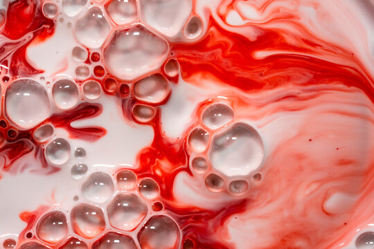 Abstract red and white liquid texture with bubbly foam &ndash; Metaphor for passion, intensity, and vitality
