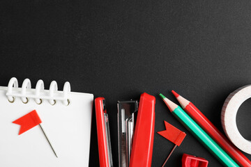 Different school stationery on blackboard, flat lay. Space for text © New Africa