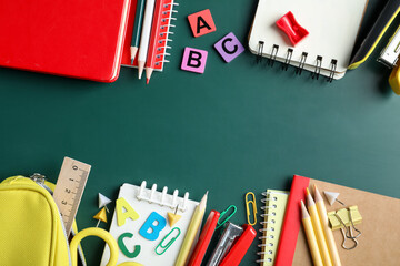 Frame made of different school stationery on blackboard, flat lay. Space for text © New Africa