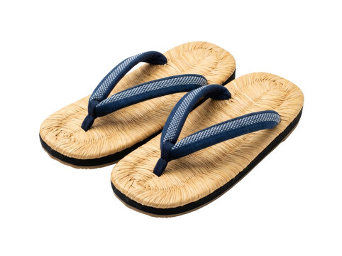 A pair of traditional Japanese woven straw zori sandals featuring comfortable dark blue hanao thongs, representing authentic cultural footwear and historic craftsmanship.