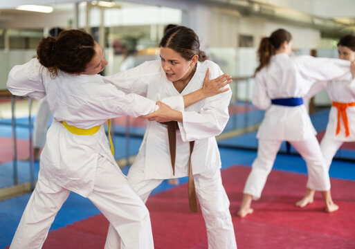Woman practices punches and blocks on the opponent. European women practice punches together for self-defense