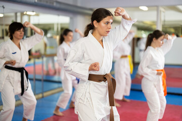 Kata karate female classes movements , fighting techniques to prepare them for competitions. Oriental martial arts, training and obtaining black belt. Sport in everyday life of city dweller.. © JackF