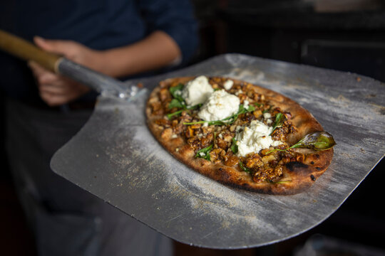 Mediterranean flatbread put in an oven