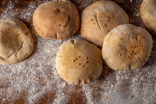 Fresh pita bread on floured board