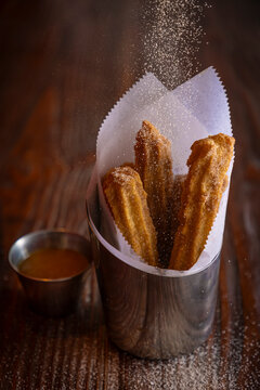  Cup of Churros with sugar pouring on them