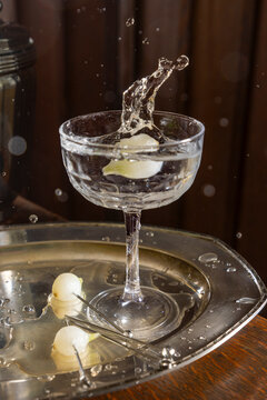 gimlet cocktail with onion splashing in