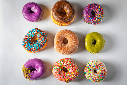 9 colorful donuts laid in grid pattern