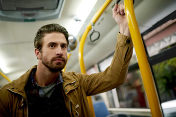 Destination, public transportation and travel with man on bus for commute in city as holiday or vacation passenger. Balance, coach and shuttle with person waiting in vehicle for journey or trip © peopleimages.com