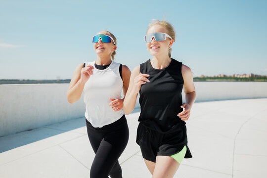 Enjoying a sunny afternoon while jogging with friends by the waterfront