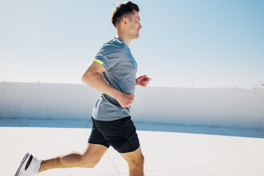 Runner enjoying a sunny day on an outdoor track, embracing fitness and vitality