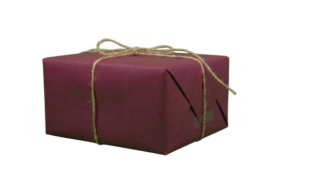 Burgundy gift box wrapped in matte paper with twine string, rustic holiday present for Christmas or birthdays, elegant maroon parcel tied with jute cord isolated PNG with Transparent Background
