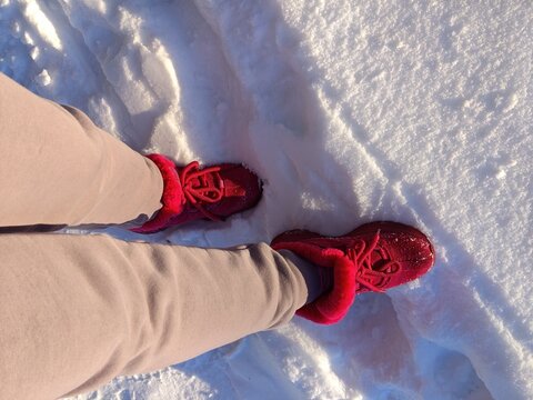 Warm red boots in fresh winter snow