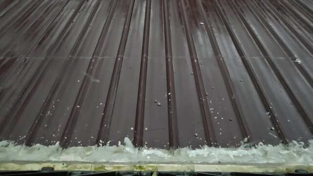 Heavy Rain Splashing on Wet Brown Corrugated Metal Roof
