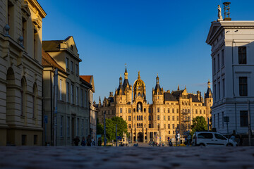 Fototapeta premium Schloss Schwerin rises above the water. Schloss Schwerin anchors European travel photography. Aerial view frames Schloss Schwerin clearly. Germany features Schloss Schwerin as landmark.