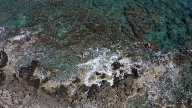 Drone flight over a rocky coast with sea surf near Kolymbari, West Crete, Crete, Greece