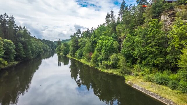 Timelapse at Lake H&ouml;llsteinsee on the Black Regen River in the Regen region, located in the Bavarian Forest National Park, Bavaria, Germany. Scenic renewable energy infrastructure surrounded by fore