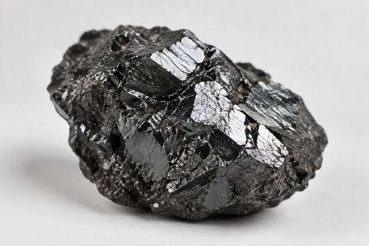 A specimen of black magnetite ore with metallic luster.