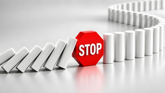 Red stop sign halting falling white dominoes preventing chain reaction in business crisis concept