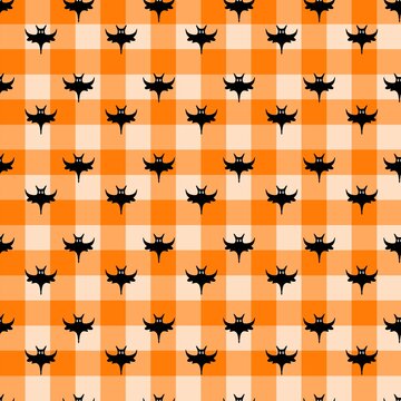 Cute Black Bats on Orange Gingham &mdash; Playful Halloween Plaid Seamless Pattern. perfect for children&rsquo;s apparel, party decor, trick-or-treat bags, nursery, stationery, and all cheerful Halloween projects