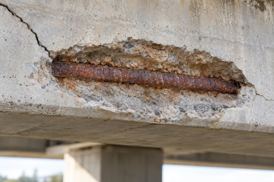 Corrosion induced concrete spalling exposing bridge rebar