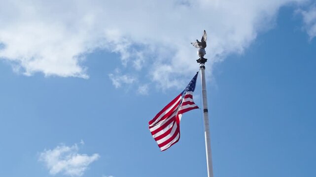 American flag in Washington DC. 4th of July. American flag waving in the wind. Flag of the USA. National waving flag of united states on blue sky. Independence day. Patriotic symbol