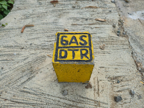 Yellow Gas DTR Marker Box on Concrete Pavement, Industrial City Gas Pipeline Utility Indicator