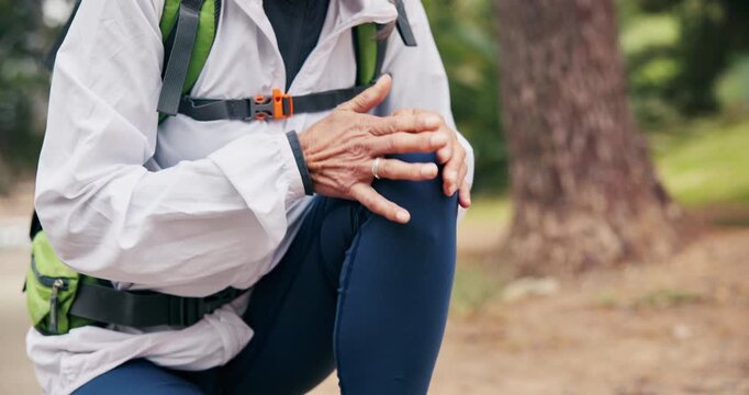 Hiking, hands or old woman in nature with knee pain, joint injury or burnout in fitness activity. Discomfort, tension or senior person with massage, wellness risk or leg strain in retirement trekking