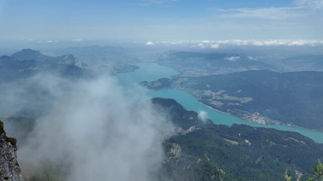 Aerial view of mountain landscape. Landscape panorama. Misty landscape with mountain lake in nature. Mountain peak aerial view. Aerial misty landscape. Scenic nature over lake. Aerial nature panorama