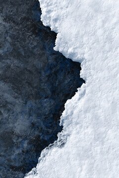 Polar albedo effect landscape with snow and dark volcanic earth for environmental sustainability branding
