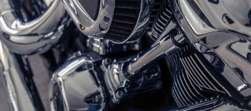 Close up of a polished motorcycle engine with chrome metal parts and cooling fins, showing mechanical detail and craftsmanship for automotive, transportation, engineering and custom motorbike themes