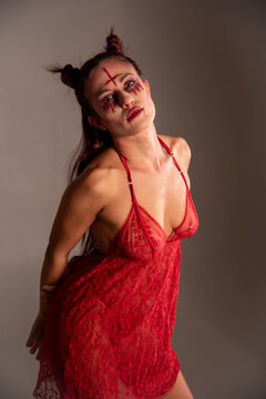 Woman posing as demon with inverted cross makeup
