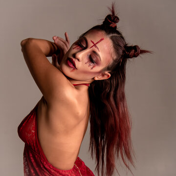 Woman portraying devilish character with expressive makeup
