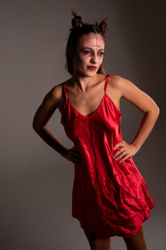 Woman posing in red devil costume for halloween