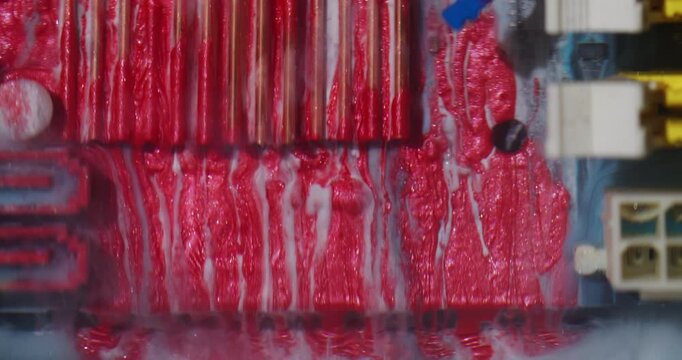 Red ink spill. Digital abstraction. Defocused vibrant blue yellow color steam uneven texture round glitter on water electronic background.
