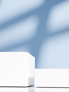 Close up of white cube podiums with window shadow on pastel blue wall. 3D minimalist clean aesthetic background mockup for product showcase.