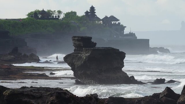 Majestic Sea Outcrop With Temple Silhouette, Powerful Swell And Crashing Surf, Layered Cliffs Receding Into Mist, Distant Balinese Shrine On Headland, Moody Clouds And Dramatic Light, Tanah Lot