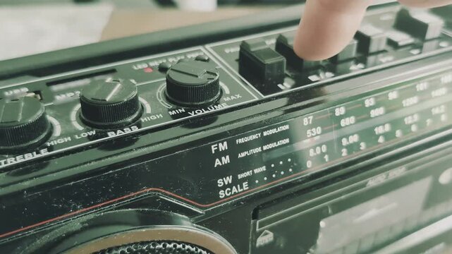 Ejecting a cassette from an old tape recorder from the eighties in a quiet room, dust gathers on the device