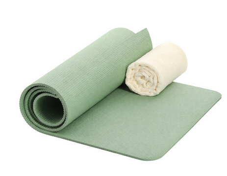 Green yoga mat rolled up with a white towel isolated on transparent background