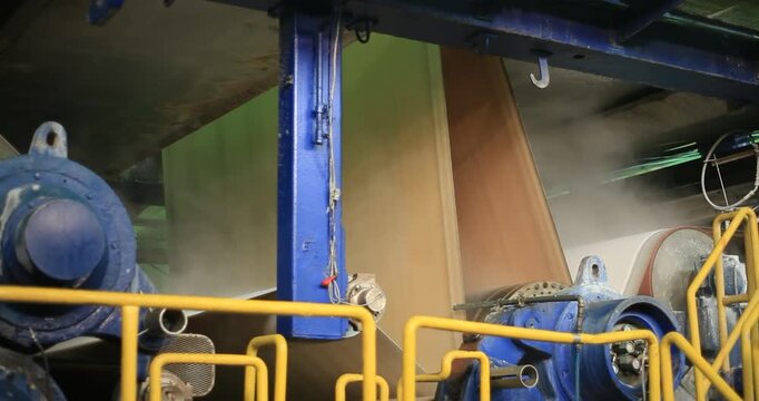 Process: A sheet of paper pulp is fed through a giant steel cylinder .