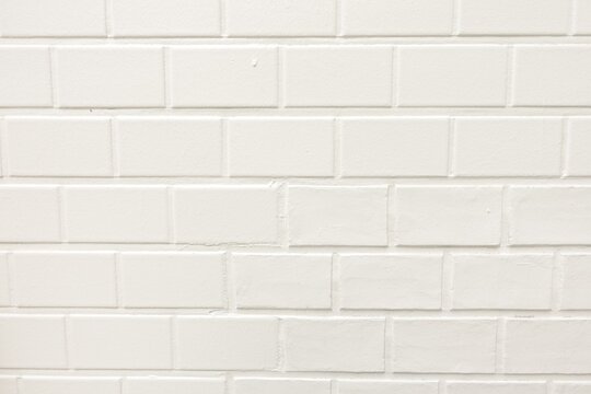 White painted brick wall texture photo with stylish pale mortar lines and a bright staggered pattern