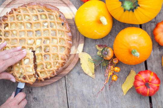Homemade Lattice Apple Pie with Autumn Pumpkins and Fresh Fruits on Rustic Wooden Table