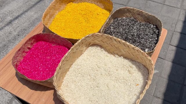 Four boxex with colorful rice top view for ceremony in Bali