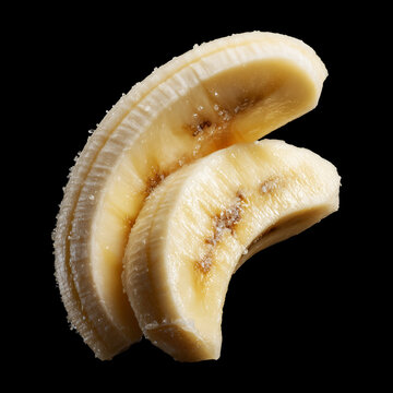 Closeup of fresh banana slices isolated on black background with clipping path, concept of freshness and healthy food