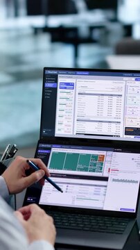 Fin-ops Manager Analyzes Cloud Spend Using Dual Laptops